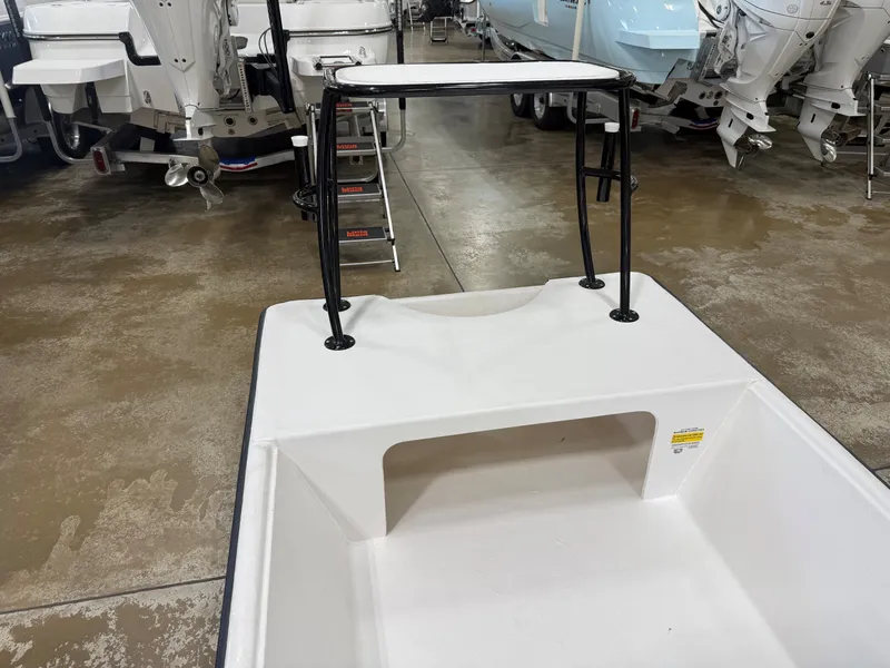 Slide: The Image of A 2027 Delta 1550 boat with a white deck and black railing. - 4