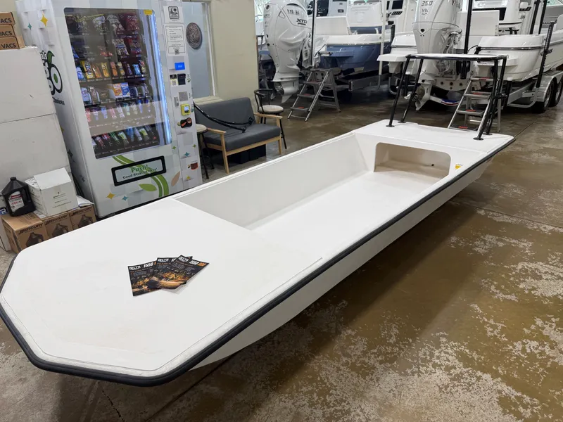 Slide: The Image of A 2027 Delta 1550 boat in a showroom. It features a simple, white design. - 6