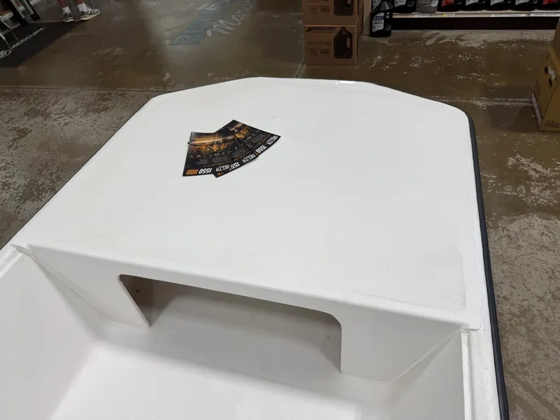 Slide: The Image of A white boat deck with a rectangular cutout and flyers on it, in an indoor setting. - 2