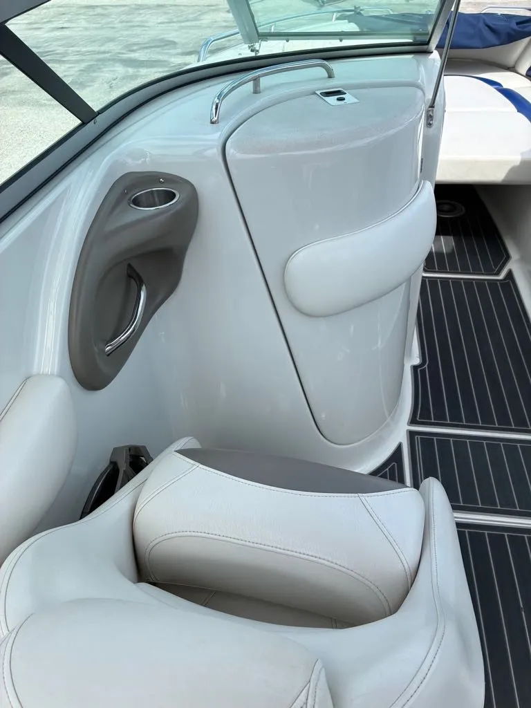 Slide: The Image of The image shows the interior of a 2007 Crownline 270BR boat with white upholstery. - 9