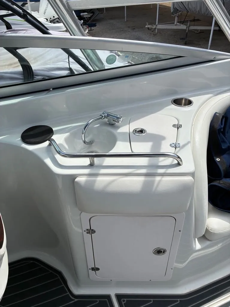 Slide: The Image of The image shows a compact boat galley with a small sink and storage below. - 10