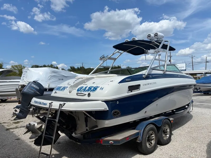 Slide: The Image of A 2007 Crownline 270BR on a trailer. It features a blue and white design with a tower. - 7