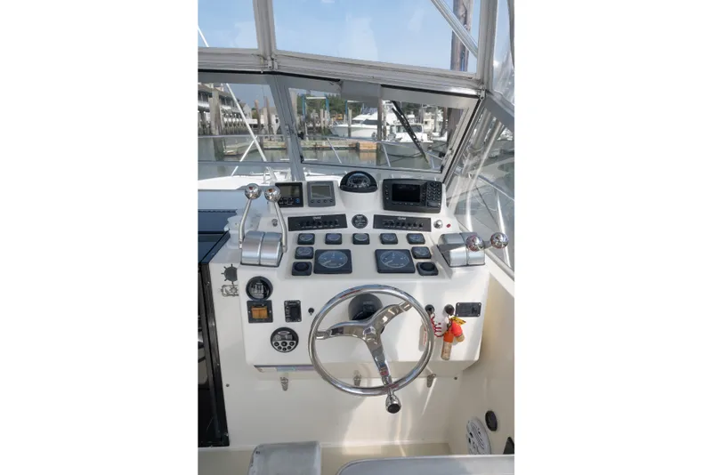 Slide: The Image of Helm of 2001 Carolina Classic 28 Express boat with navigation instruments and controls. - 5