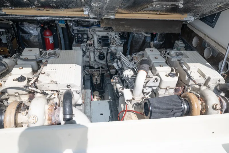 Slide: The Image of Engine room of a 2001 Carolina Classic 28 Express boat, showcasing dual engines and equipment. - 17