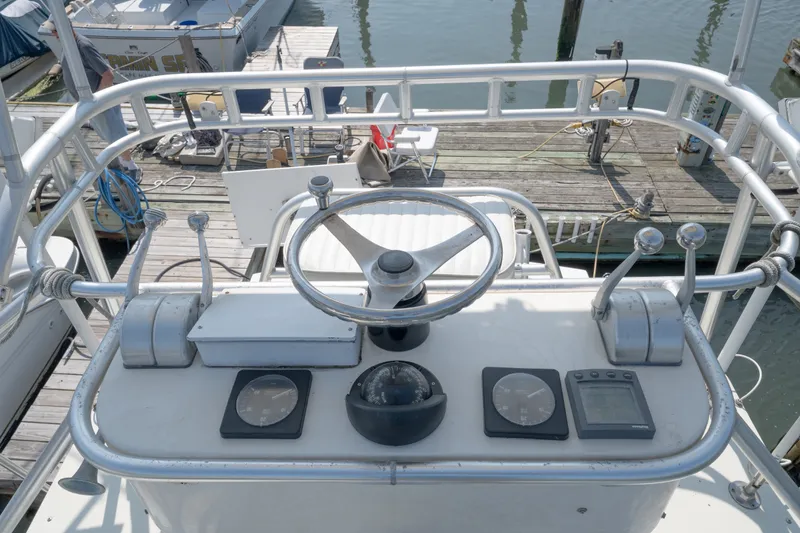 Slide: The Image of Helm of 2001 Carolina Classic 28 Express boat with steering wheel and controls. - 16