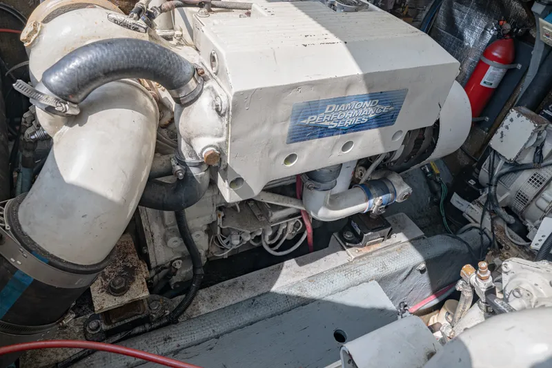 Slide: The Image of Engine compartment of a 2001 Carolina Classic 28 Express boat, featuring Diamond Performance Series engine. - 18