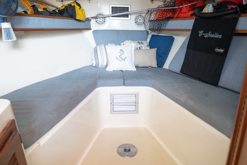 Slide: The Image of Cozy cabin interior of 2001 Carolina Classic 28 Express boat with cushions and storage. - 10