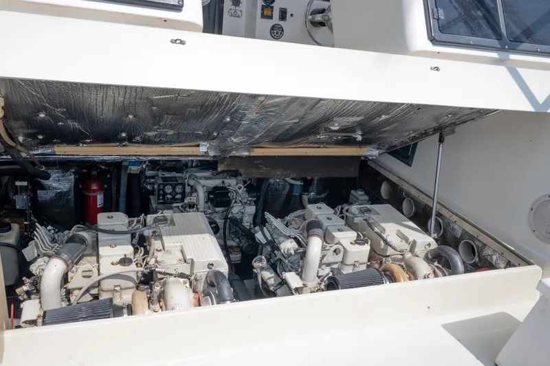 Slide: The Image of Engine compartment of a 2001 Carolina Classic 28 Express boat, showcasing dual engines. - 19