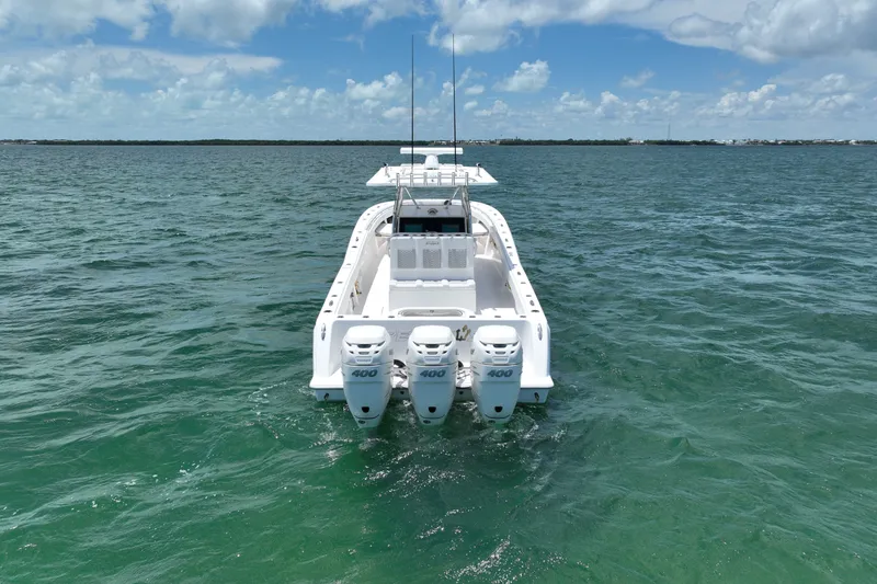 Slide: The Image of 2013 Invincible 42 Open Fisherman boat with triple 400 engines on open water. - 3