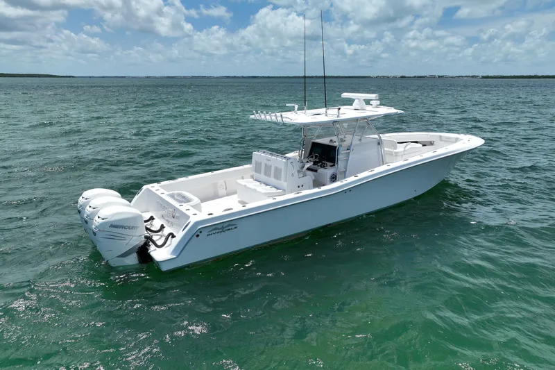 Slide: The Image of 2013 Invincible 42 Open Fisherman boat on clear ocean water under blue sky. - 5