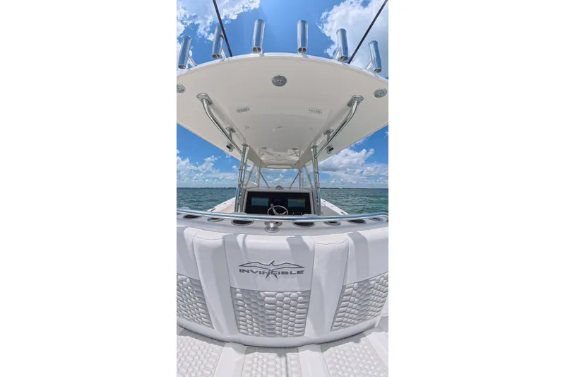 Slide: The Image of 2013 Invincible 42 Open Fisherman boat on open water under clear blue sky. - 26