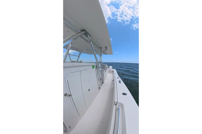 Slide: The Image of 2013 Invincible 42 Open Fisherman boat on open sea under clear blue sky. - 17