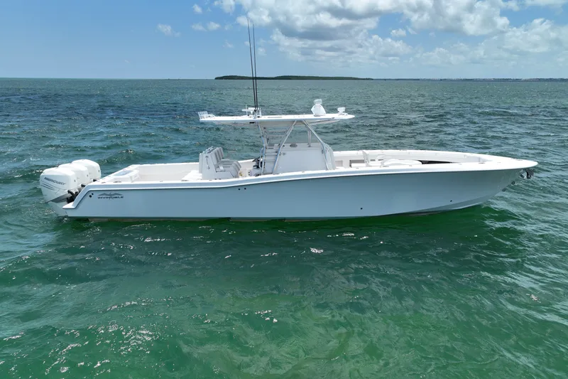 The Image of 2013 Invincible 42 Open Fisherman boat on clear ocean water under blue sky. - 0