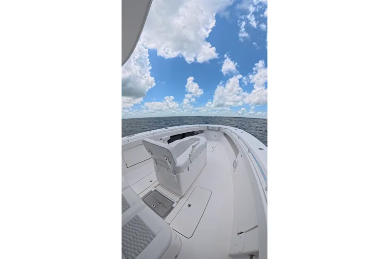 Slide: The Image of 2013 Invincible 42 Open Fisherman boat on open water under a cloudy sky. - 12