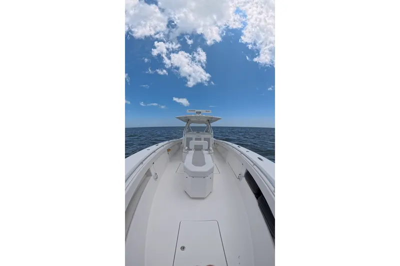Slide: The Image of 2013 Invincible 42 Open Fisherman boat on open sea under blue sky. - 15