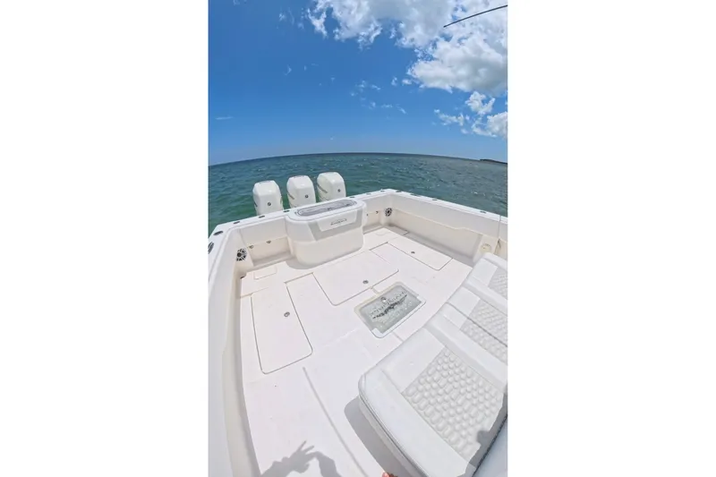 Slide: The Image of 2013 Invincible 42 Open Fisherman boat deck with ocean view under blue sky. - 21