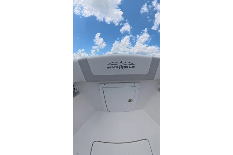 Slide: The Image of 2013 Invincible 42 Open Fisherman boat under a blue sky with clouds. - 14