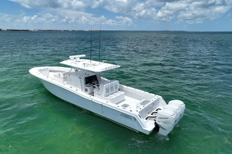 Slide: The Image of 2013 Invincible 42 Open Fisherman boat on clear ocean water under blue sky. - 2