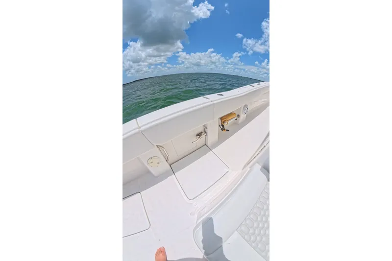 Slide: The Image of 2013 Invincible 42 Open Fisherman boat on open water under a blue sky. - 23