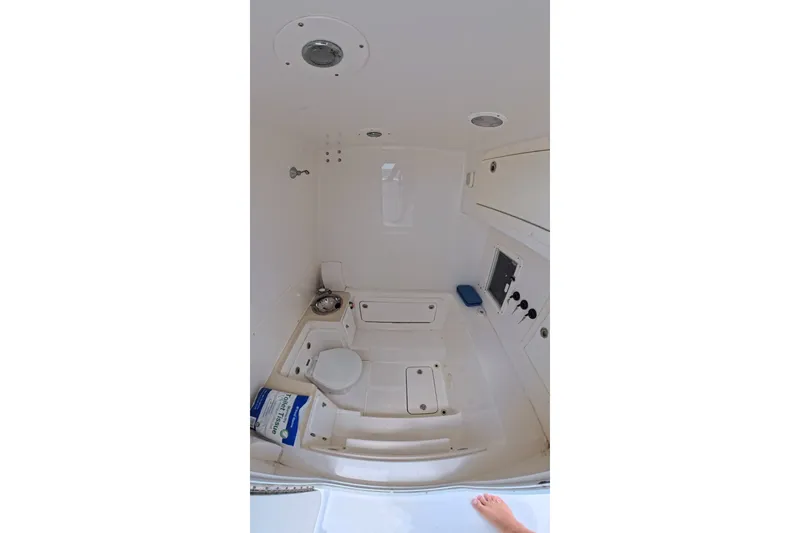 Slide: The Image of Interior of 2013 Invincible 42 Open Fisherman boat, featuring a compact bathroom setup. - 30