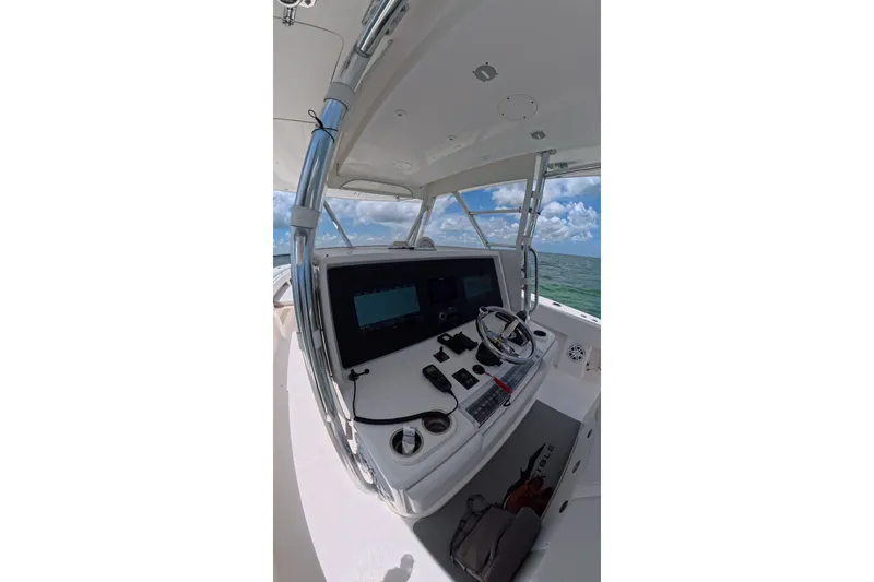 Slide: The Image of Helm of 2013 Invincible 42 Open Fisherman boat with ocean view. - 27