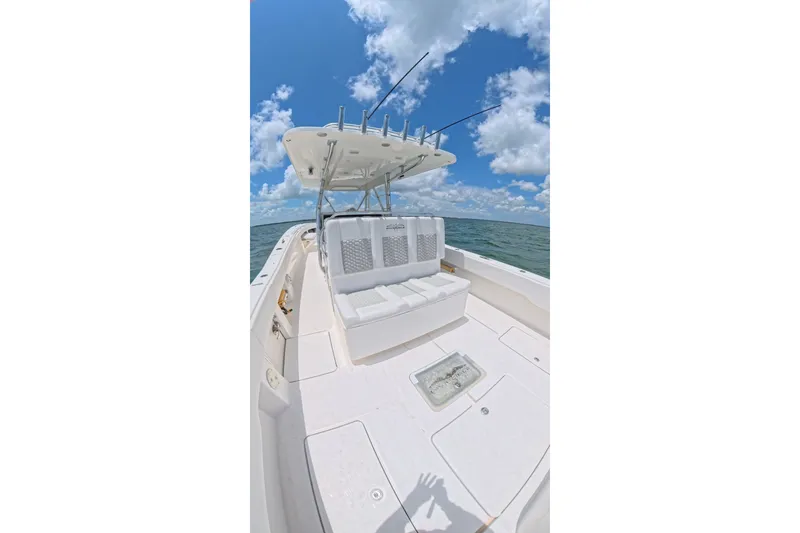 Slide: The Image of 2013 Invincible 42 Open Fisherman boat on open water under blue sky. - 22