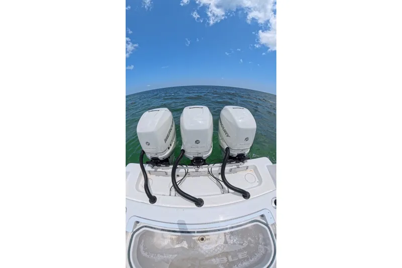 Slide: The Image of 2013 Invincible 42 Open Fisherman with triple Mercury outboard engines on open sea. - 25