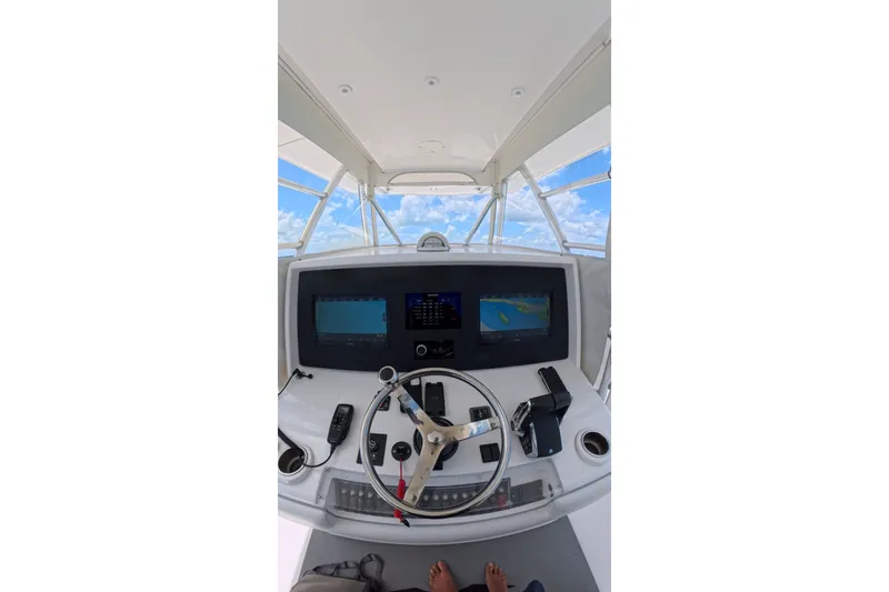 Slide: The Image of Cockpit view of 2013 Invincible 42 Open Fisherman boat with navigation screens. - 20