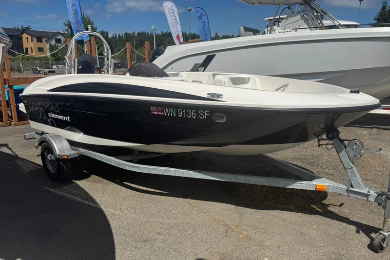 The Image of 2014 Bayliner 160 Element boat on trailer, displayed outdoors under clear sky. - 0