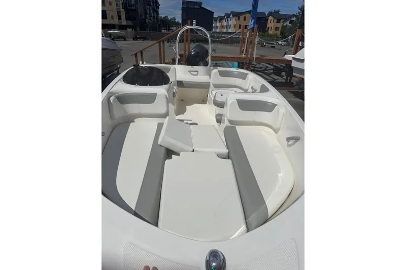 Slide: The Image of 2014 Bayliner 160 Element boat interior with white seating and open deck layout. - 9