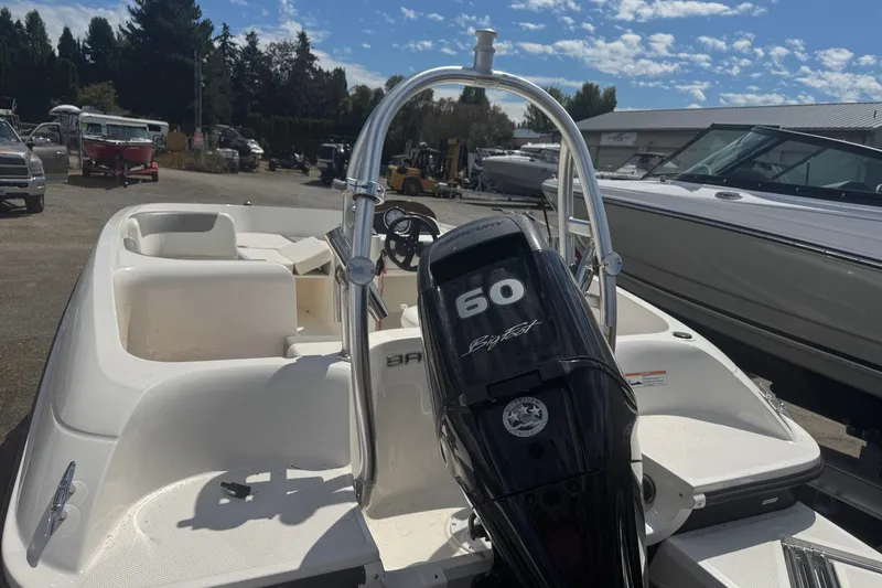 Slide: The Image of 2014 Bayliner 160 Element boat with 60 horsepower engine, parked outdoors under a blue sky. - 8