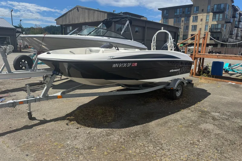 Slide: The Image of 2014 Bayliner 160 Element boat on trailer in marina setting, sunny day. - 1
