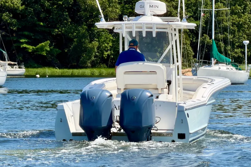 Slide: The Image of A 2014 Buddy Davis 28 Center Console boat cruising on calm waters. - 3