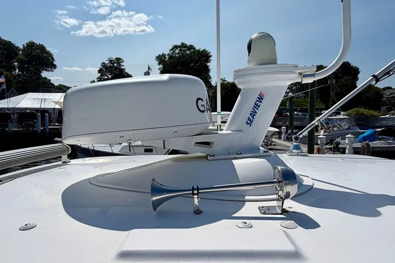 Slide: The Image of The image shows the roof of a boat with a radar and a horn. - 21