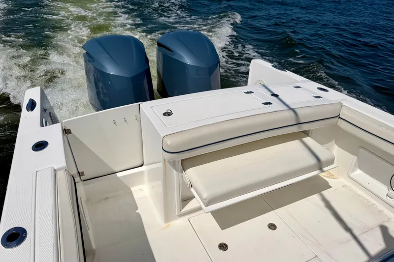 Slide: The Image of The image shows the stern of a 2014 Buddy Davis 28 Center Console boat with twin outboard engines. - 12