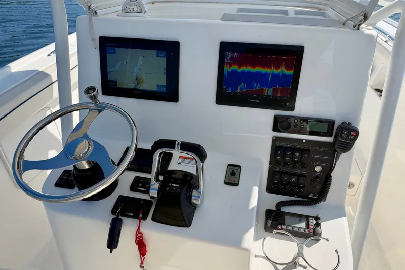 Slide: The Image of The image shows a boat's helm with two screens and various controls. - 15