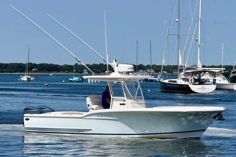 The Image of A white 2014 Buddy Davis 28 Center Console boat on calm water with other boats in the background. - 0