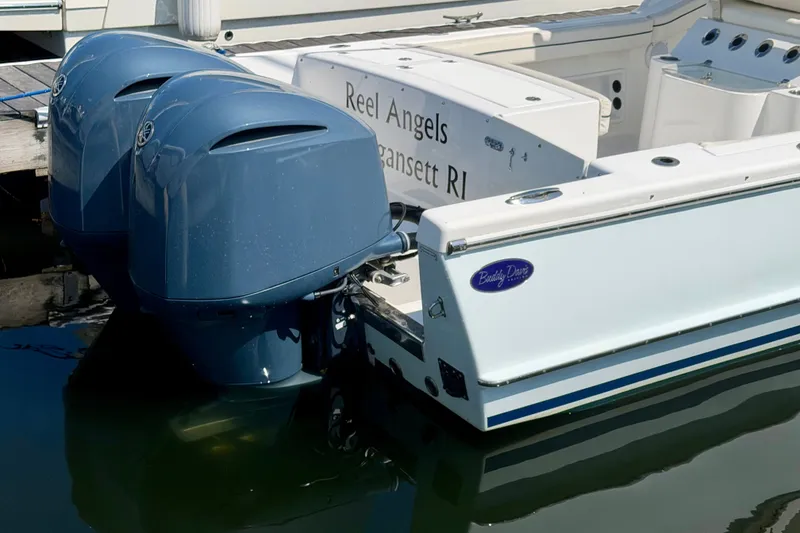 Slide: The Image of A 2014 Buddy Davis 28 Center Console boat with twin outboard engines in the water. - 25