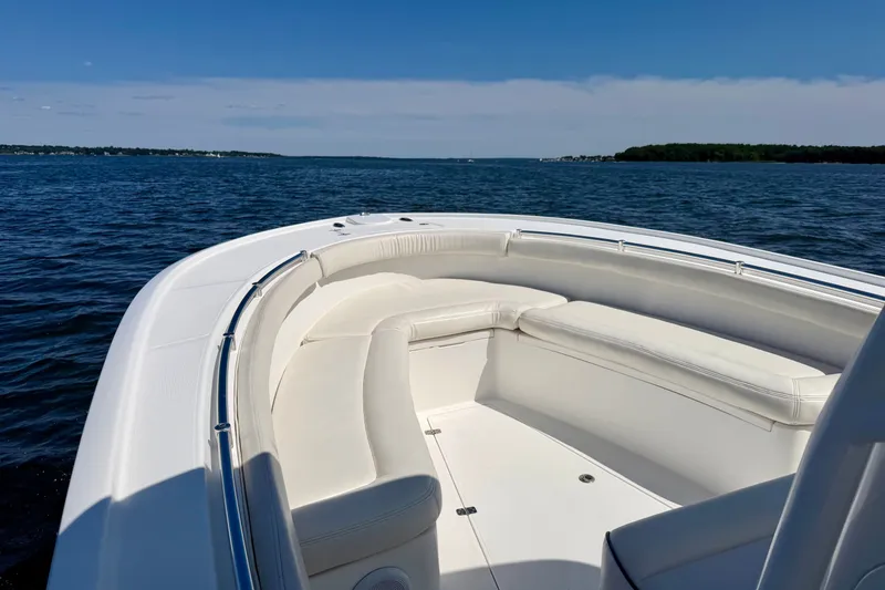 Slide: The Image of The image shows the bow of a 2014 Buddy Davis 28 Center Console boat on calm water. - 6