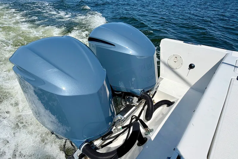 Slide: The Image of Two outboard engines on a boat in the water, with splashing water in the background. - 10