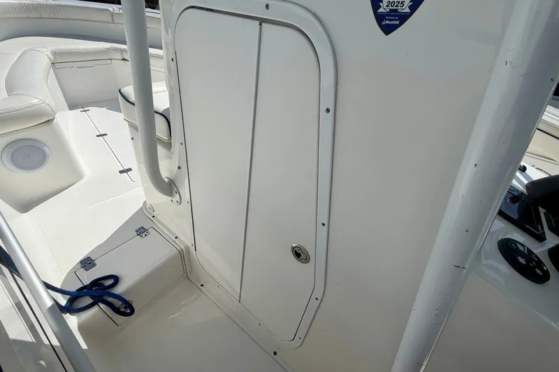 Slide: The Image of The image shows the cockpit of a 2014 Buddy Davis 28 Center Console boat with white upholstery. - 16