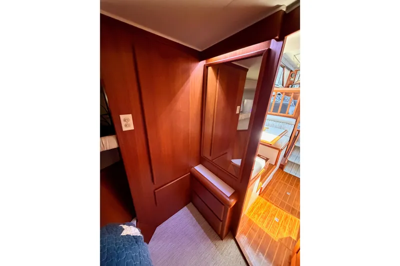 Slide: The Image of Interior of 1990 Californian 48 Motor Yacht with wooden cabinetry and cozy seating area. - 79