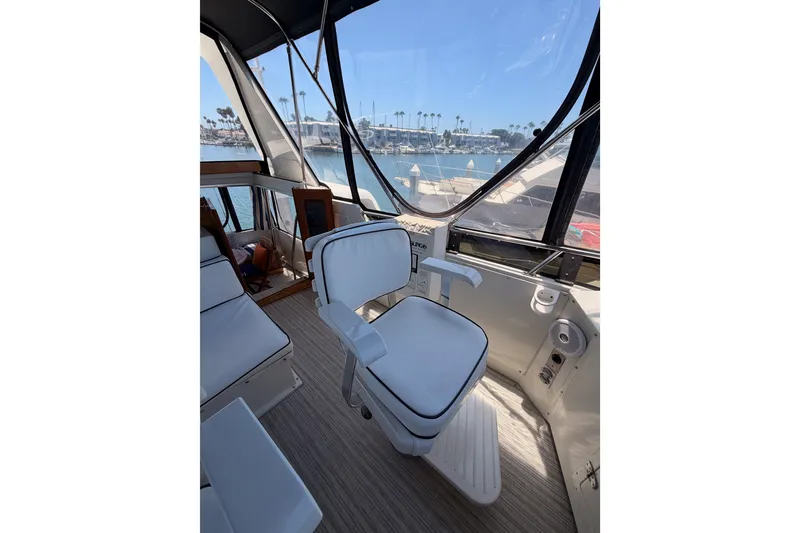 Slide: The Image of Cockpit of 1990 Californian 48 Motor Yacht with marina view. - 50