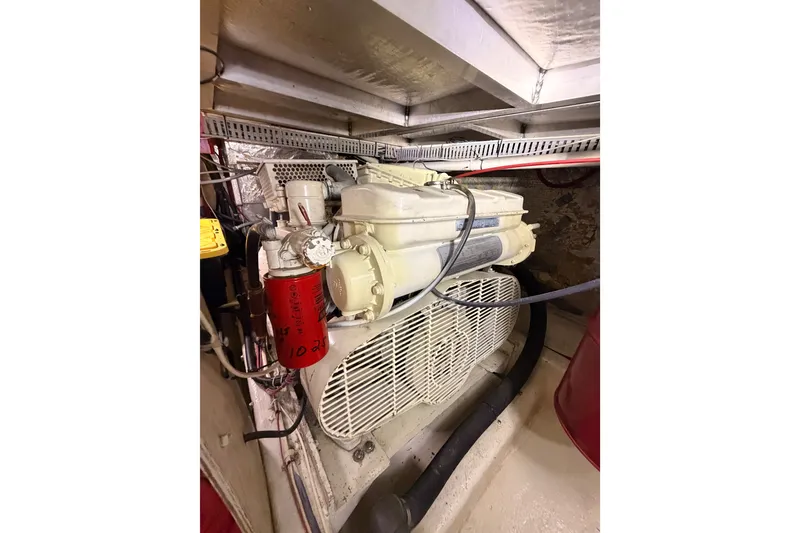 Slide: The Image of Engine room of 1990 Californian 48 Motor Yacht, showcasing mechanical components and wiring. - 111