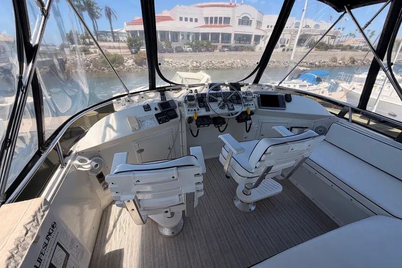 Slide: The Image of Cockpit of 1990 Californian 48 Motor Yacht with steering wheel and navigation equipment. - 36