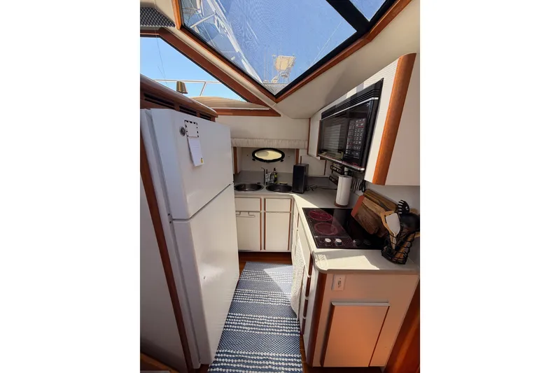 Slide: The Image of Interior kitchen of 1990 Californian 48 Motor Yacht with modern appliances and skylight. - 64