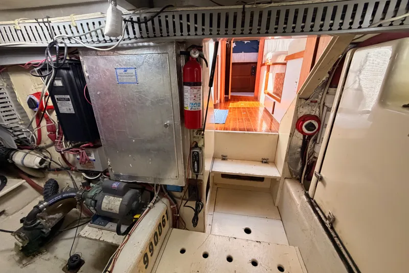 Slide: The Image of Engine room of a 1990 Californian 48 Motor Yacht with visible equipment and wiring. - 122