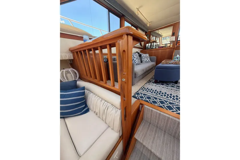 Slide: The Image of Interior of 1990 Californian 48 Motor Yacht with cozy seating and nautical decor. - 85
