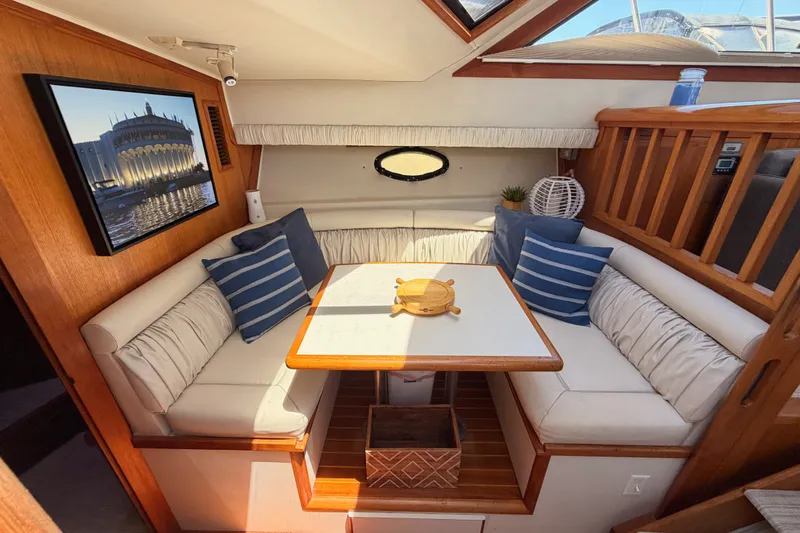 Slide: The Image of Interior of 1990 Californian 48 Motor Yacht with cozy seating and nautical decor. - 67