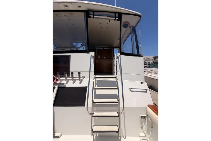 Slide: The Image of 1990 Californian 48 Motor Yacht with rear deck and stairs under clear blue sky. - 14